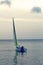 Girl boarding Laser sailboat