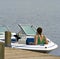 Girl in boat tied to dock