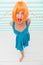 Girl bob wig posing striped background of studio. Create your own mood. Lady red or ginger wig posing in blue dress