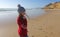 Girl in a bobble hat on the beach in Portugal in winter