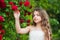 Girl botany garden red roses skin care, organic cosmetics concept