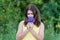 Girl with bouquet of blue wild flowers outside in summer