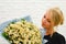 Girl with a bouquet of delicate daisies. girl with wildflowers. flower present