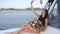 Girl with bouquet of flowers Does selfie on sail boat at summer rest in sea