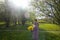 Girl with a bouquet of yellow rape. In the spring meadow. The sun shines brightly