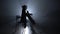 Girl bows the cello in a smoky room at night. Silhouette. Black smoke background