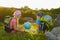 Girl and boy with backpacks and globe resting outdoor. Adventure, travel concept