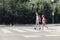 Girl and boy with backpacks walking on pedestrian crossing