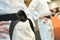 Girl and boy with black belt in martial arts