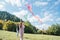 Girl and boy brother with flying colorful kites on the high green grass meadow in the mountain fields. Happy childhood moments or