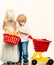 Girl and boy children shopping. Kids store. Couple kids hold plastic shopping basket toy. Buy with discount. Family