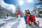 Girl and boy enjoying sleigh ride. Child sledding. Toddler kid r