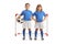 GIrl and boy in football jerseys posing with a ball in front of a goal