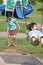 Girl & boy in the park swinging