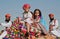 Girl and a boy ride on a camel in the crowd of soldiers Rajasthan