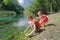 Girl and boy siblings playing near water of Italian Tirino river