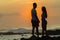 Girl Boy Silhouetted Beach Sunrise Ocean