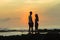 Girl Boy Silhouetted Beach Sunrise Ocean