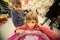 Girl and boy sit in shoppingcart, play new toy