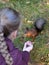 Girl with braid feeding Eurasian red squirrel outdoor