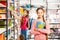 Girl with braid stands, holds notebook in library