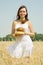 Girl with bread at cereals field