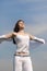 Girl breathes in fresh air on a blue sky background.