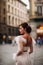 Girl-bride wedding dress with a beautiful floral pattern in Florence, stylish bride in a wedding dress stands in the Old city of