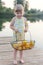 Girl on the bridge with lemons on the background of the reservoir, rest, family, holiday