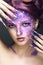 Girl with bright purple creative makeup with crystals and long nails. Beauty face.