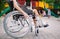 A girl with a broken leg sits in a wheelchair in front of the playground