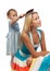 Girl brushes hair of mum