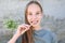 A girl brushes her teeth siwak stick. Miswak sticks