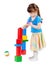 Girl build a tower of toy bricks