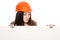 Girl builder in helmet looking at a blank banner