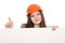 Girl builder in helmet showing thumbs up with blank banner.