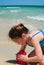 Girl building sandcastle on beach