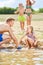 Girl builds a sandcastle with her father