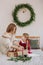 Girl burgundy dress mother Christmas rustic room