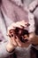 Girl with burgundy manicure keeps chestnuts