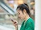 Girl busy with a smart phone in a shopping mall, Beijing, China