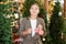 Girl buyer considers New Year and Christmas decorations ornaments for Christmas tree