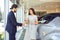 Girl buyer shakes hands dealer car