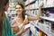 Girl buying cosmetical cream in the shopping mall