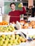 Girl buying ripe pineapple