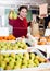 Girl buying ripe pineapple