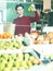 Girl buying ripe pineapple