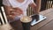 A girl in a cafe is stirring delicious aromatic coffee and using a tablet. woman chatting drinking coffee and resting.