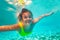 Girl calmly swim underwater on in the warm sea