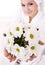 Girl with camomile and white towel on head .